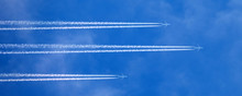 Huge Passenger Planes Fly High In The Sky One Behind Another
