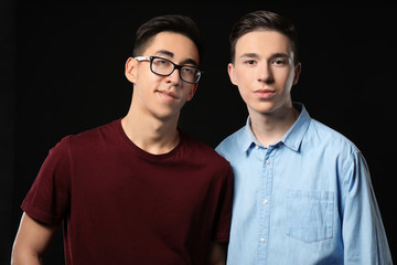 Wall Mural - Cool teenage boys on dark background