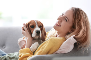 Wall Mural - Young woman with her dog at home