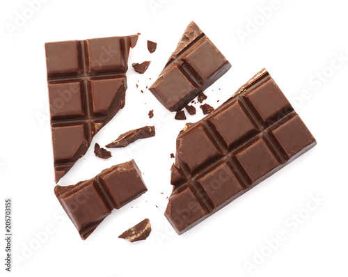 Plakat Delicious black chocolate on white background, top view