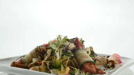 Wall Mural - Delicious vegetable salad mixed with mushroom, cucumber, carrot, corn, zucchini, sweet pepper, tomato, onion, greens and cheese on plate on white background. Modern molecular gastronomy.