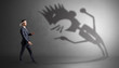 © ra2 studio - Young karate man fighting with a big black scary shadow