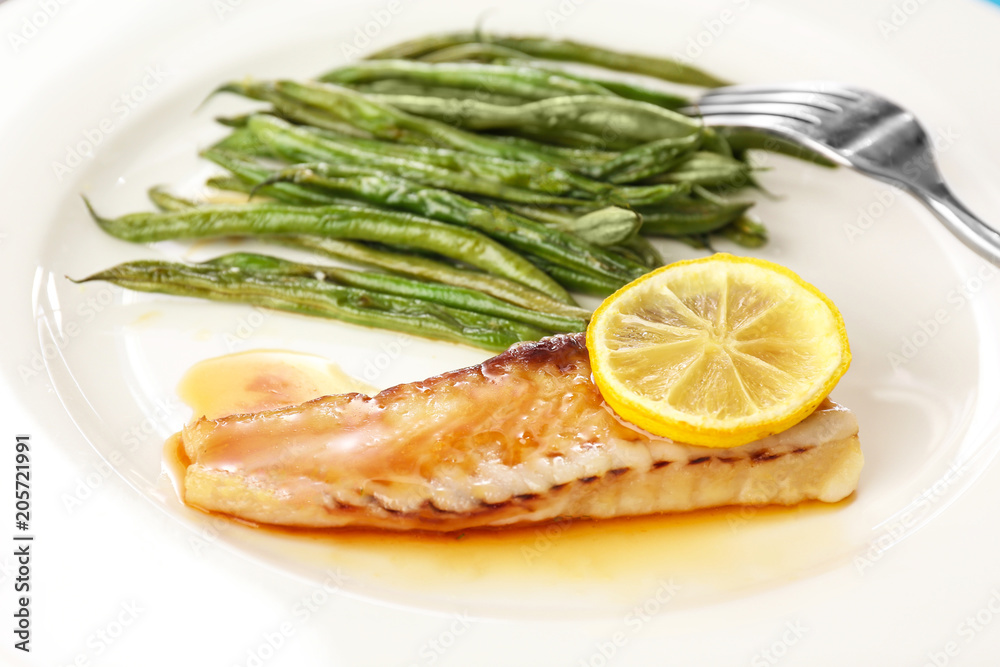 Plate with tasty fish and green beans, closeup