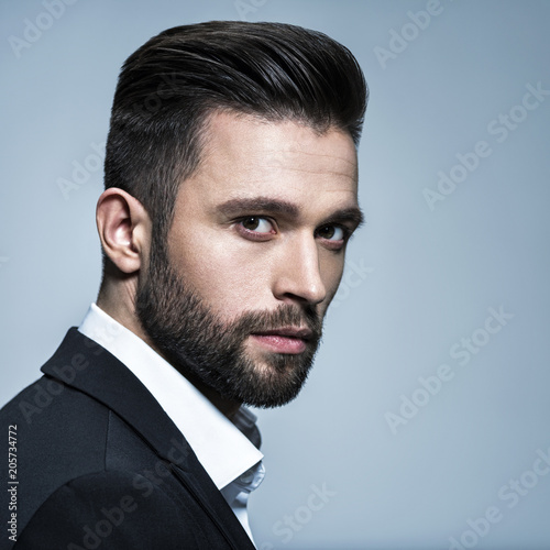 Cuadros en Lienzo Handsome man in black suit with white shirt