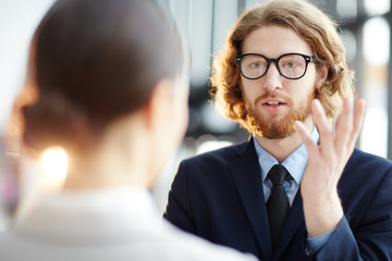 Sticker - Bearded businessman in eyeglasses discussing situation with dollar rate on stock market with his colleague