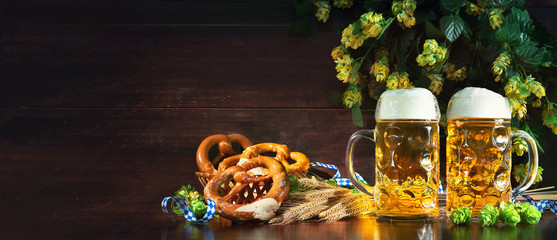 Poster - Bavarian beer with soft pretzels, wheat and hop on rustic wooden table