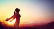 Leinwandbild Motiv Freedom And Healthy Concept - Beautiful Young Girl Against Sunset

