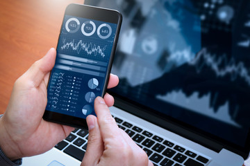 Aufkleber - Investor analyzing stock market report and financial dashboard with business intelligence (BI), with key performance indicators (KPI).Businessman using smart phone with laptop computer.