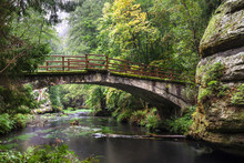 Old Bridge In The Forest At The Rocks