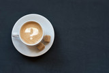 Fototapeta Mapy - Cup of coffee with milk, cane sugar and question mark on dark background. Top view. Copy space