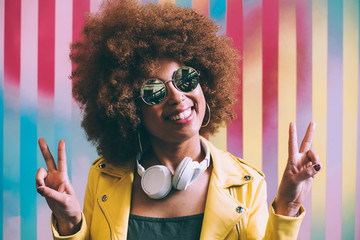 Mixed race woman in a colorful artwork background wall