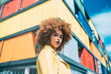 Mixed race woman in a multicolor houses background