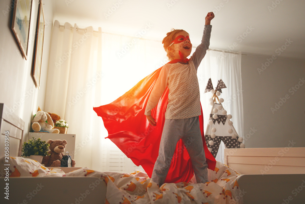 child girl in a super hero costume with mask and red cloak - obrazy, fototapety, plakaty 