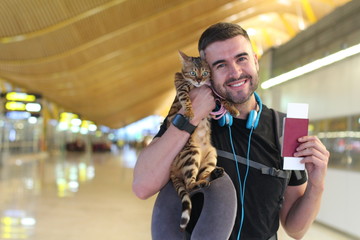 Handsome man traveling with his cat