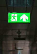 Green Emergency Exit Sign In Public Building.

