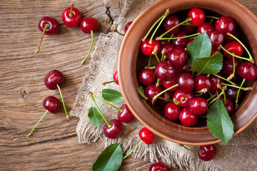 Wall Mural - Fresh cherry in bowl on wooden background. vegetarian food. Summer time.