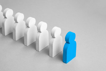 Concept leader of the business team indicates the direction of the movement towards the goal. Crowd of white men goes for the leader of the blue color