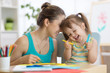 © Oksana Kuzmina - Young mother with little child daughter fun cut scissors colored paper