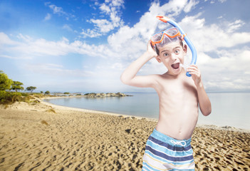 Happy little boy with snorkeling mask enjoying his summer vacations