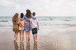 © Kike Arnaiz/ADDICTIVE STOCK - Rear view of family enjoying beach