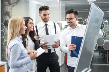 Group of business people looking at the graph on flipchart