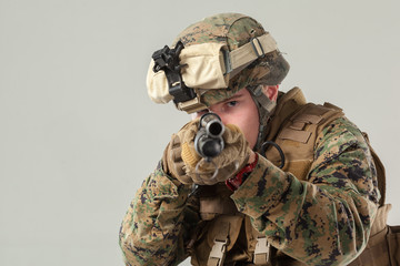 Wall Mural - Soldier in camouflage holding rifle