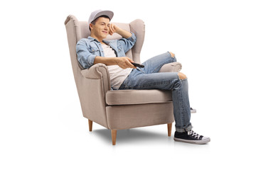 Poster - Teenage boy seated in an armchair watching television