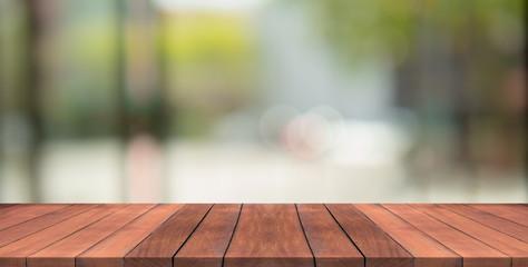 Empty wood table top on nature green blurred background at garden,space for montage show products