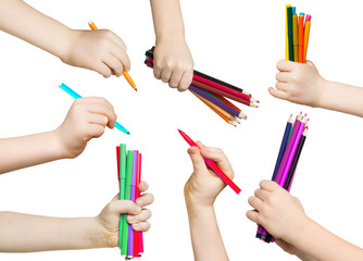 Wall Mural - Set of child hands holding pencils and felt pens