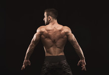 Unrecognizable Man Shows Strong Back Muscles Closeup