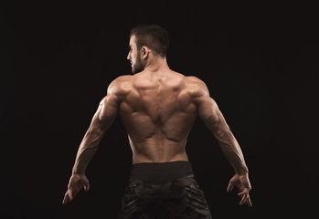 Unrecognizable man shows strong back muscles closeup