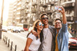 © BalanceFormCreative - Group of friends hangout  at the city street.They embrace each other and doing selfie.