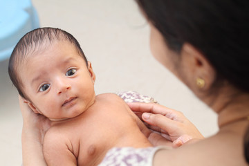 Cheerful mother holding newborn baby