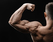 Bodybuilder in good shape against a dark background