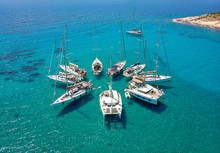 Stunning Aerial View Of Sailing Boats In Turquoise Tropical Bay Arranged In A Star Formation