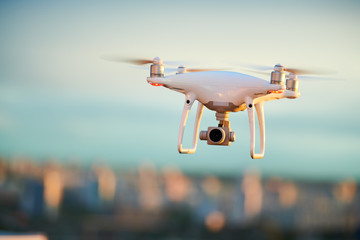 Wall Mural - drone flying over evening city with digital camera