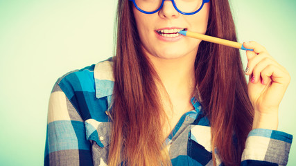 Poster - Happy nerdy woman in glasses holding pen