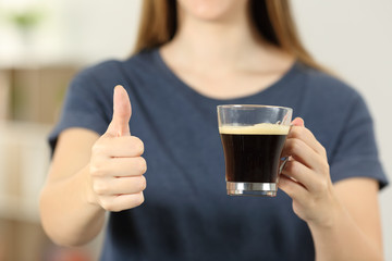 Canvas Print - Woman hands holding a coffee cup with thumbs up