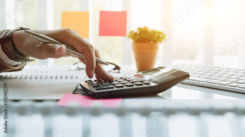 Cuadros en Lienzo Close up view of bookkeeper or financial inspector hands making report, calculating or checking balance