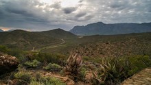 Wide View Timelapse Of Beautiful African Landscape Mountain Valley With Vegetation Aloe Vera In Foreground And Cloudy Sky
