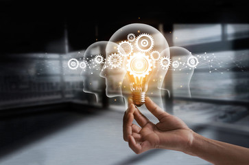 Leinwandbilder - Hand holding light bulb and cog inside. Idea and imagination. Creative and inspiration. Innovation gears icon with network connection on human heads. Innovative technology in science concept