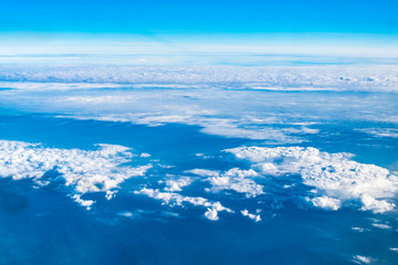 Wall Mural - blue sky and cloud top view from airplane window,nature background