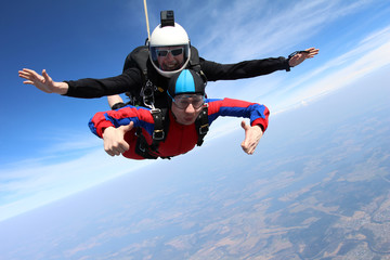 Tandem skydiving. Two men are in the sky.