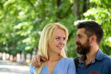 Wall Mural - Man hugs happy blonde girlfriend, put hand on her shoulder.