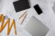 © LIGHTFIELD STUDIOS - collapsible meter, laptop, smartphone with blank screen, pencils, textbook on blueprint