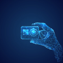 Poster - Abstract vector image of action camera in hand . Low poly wire frame illustration. Lines and dots. RGB Color mode. Video blog concept. Polygonal art.