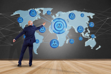 Poster - Businessman holding a Network over a connected world map - 3d render