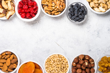 Wall Mural - Nuts and dried fruits assortment on stone table top view.