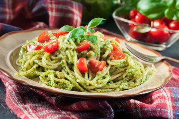 Wall Mural - Vegetarian pasta spaghetti with basil pesto and cherry tomatoes