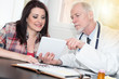 © thodonal - Doctor showing reports on digital tablet to patient, light effect